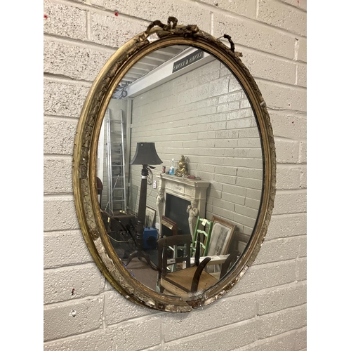 39 - Large antique oval shaped gilt framed mirror with original glass, framed needing restoration. H. 110... 