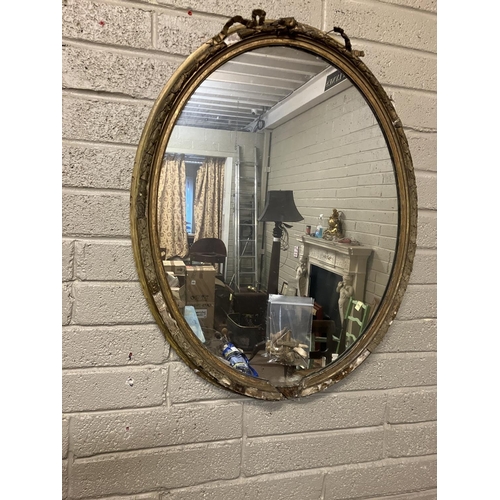 39 - Large antique oval shaped gilt framed mirror with original glass, framed needing restoration. H. 110... 