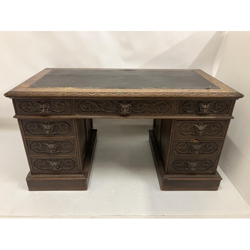 46 - Victorian carved oak pedestal desk fitted with 9 drawers. 138cm x 73cm approx.