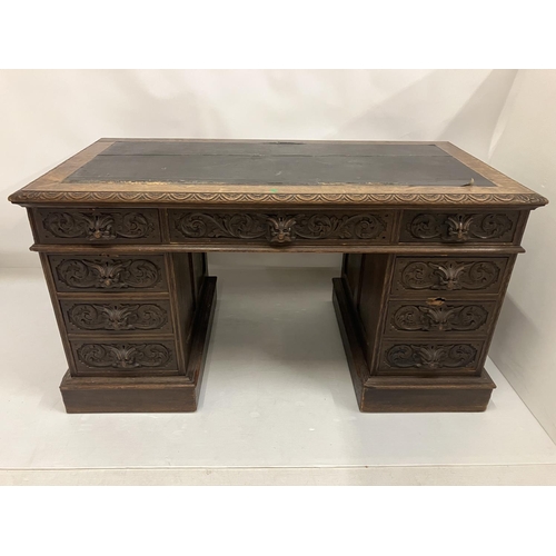 46 - Victorian carved oak pedestal desk fitted with 9 drawers. 138cm x 73cm approx.