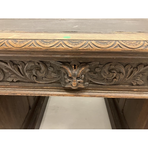 46 - Victorian carved oak pedestal desk fitted with 9 drawers. 138cm x 73cm approx.