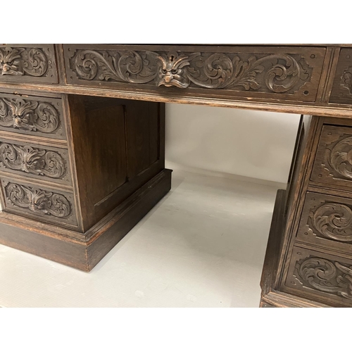 46 - Victorian carved oak pedestal desk fitted with 9 drawers. 138cm x 73cm approx.