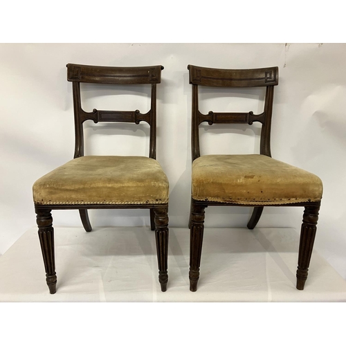 49 - In the manner of Gillows, a pair of Regency mahogany side chairs having curved top rail decorative b... 