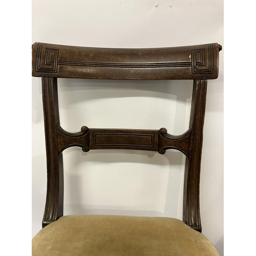 49 - In the manner of Gillows, a pair of Regency mahogany side chairs having curved top rail decorative b... 