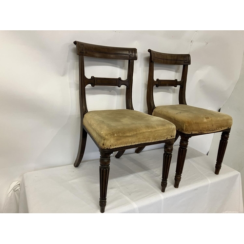 49 - In the manner of Gillows, a pair of Regency mahogany side chairs having curved top rail decorative b... 