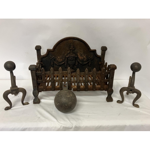 52 - An old cast iron fire grate, a pair of fire dogs with ball decoration, an old cannon ball and fender... 