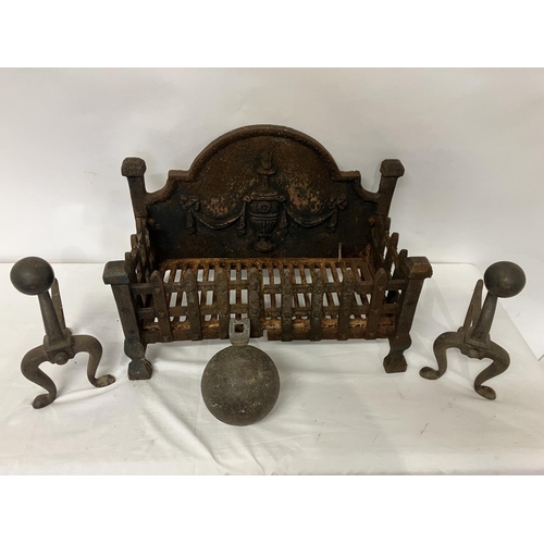 52 - An old cast iron fire grate, a pair of fire dogs with ball decoration, an old cannon ball and fender... 