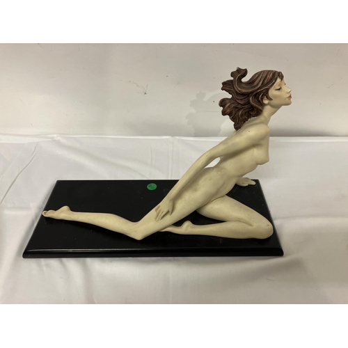 55 - Nude figure of a reclining lady on plaque.