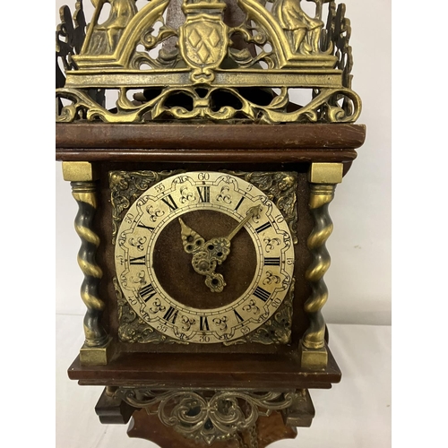 63 - Mahogany and brass mounted wall clock with pear shaped weights.