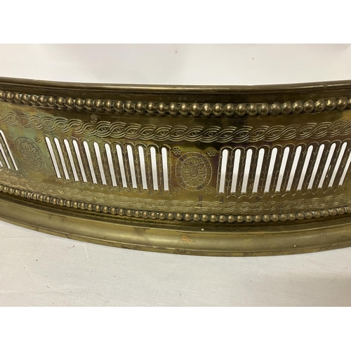 81 - A good antique brass serpentine shaped fender with engraved decoration. W. 133cm, D. 30cm approx.