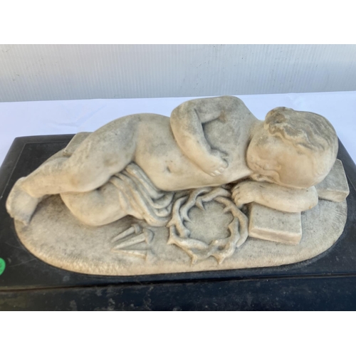 269 - Marble plaque of the Infant Jesus laying on a cross with crown of thorns and nails. Overall size 40c... 