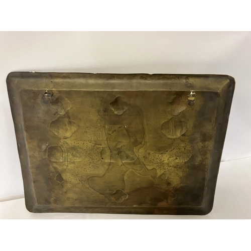 298 - An Arts and Crafts type metal plaque having brass and copper inlay and Celtic design.