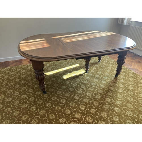 359 - Large Victorian mahogany dining table raised on 5 legs and having 1 spare leaf. (This table would ta... 