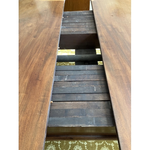 359 - Large Victorian mahogany dining table raised on 5 legs and having 1 spare leaf. (This table would ta... 