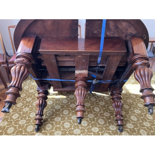 359 - Large Victorian mahogany dining table raised on 5 legs and having 1 spare leaf. (This table would ta... 