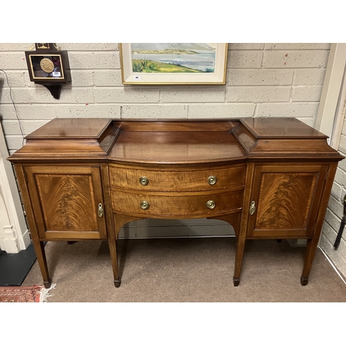 347 - Antique mahogany sideboard having nicely figured doors bow shaped drawers and raised on tapering leg... 