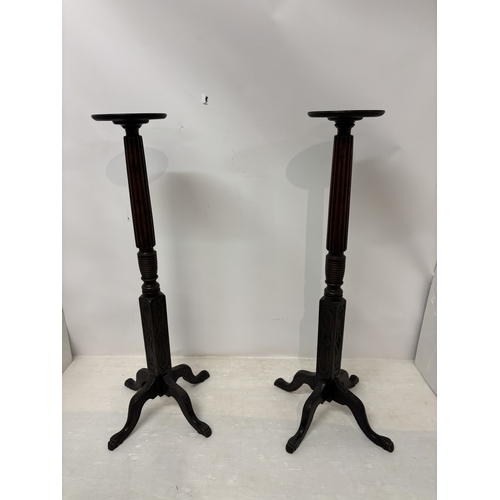 104 - A pair of antique mahogany torcheré's having fluted and carved columns and raised on 4 carved claw f... 