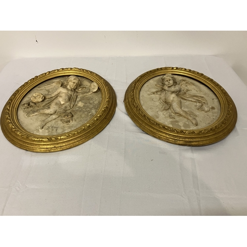 107 - A pair of antique plaques - musicians in original oval gilt frames. Overall size 55cm x 47cm.