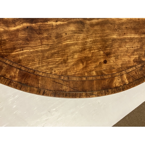 109 - A Georgian nicely figured mahogany demi lune card table, the fold over top with rosewood cross bandi... 