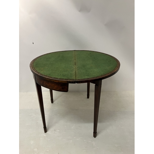 109 - A Georgian nicely figured mahogany demi lune card table, the fold over top with rosewood cross bandi... 