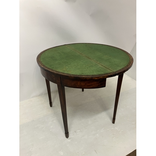 109 - A Georgian nicely figured mahogany demi lune card table, the fold over top with rosewood cross bandi... 
