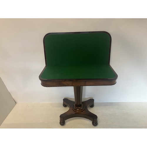112 - Victorian rosewood card table, the folding top on tapered column, platform base and turned feet. W. ... 