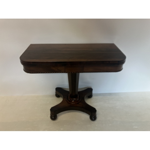 112 - Victorian rosewood card table, the folding top on tapered column, platform base and turned feet. W. ... 