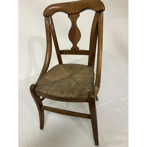 17 - A 19th century child's chair, possibly cedar wood. (one arm damaged)