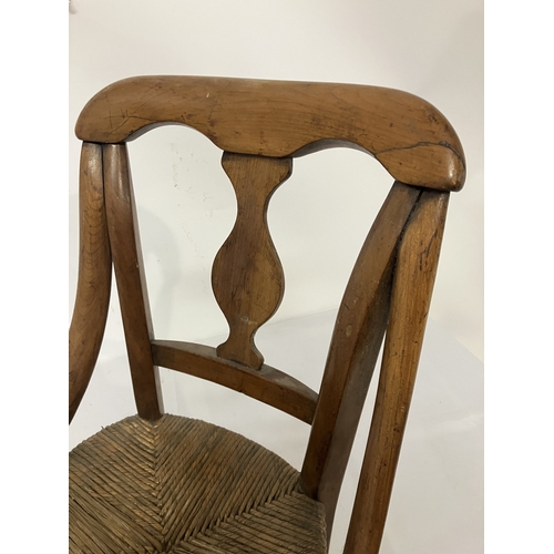 17 - A 19th century child's chair, possibly cedar wood. (one arm damaged)