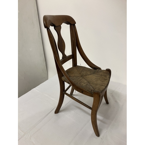 17 - A 19th century child's chair, possibly cedar wood. (one arm damaged)