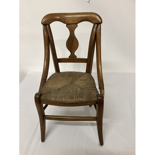 17 - A 19th century child's chair, possibly cedar wood. (one arm damaged)