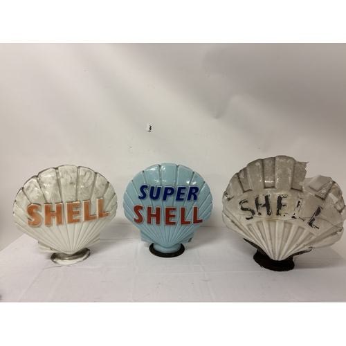 A collection of 3 Shell petrol pump tops. The small white one is in ...