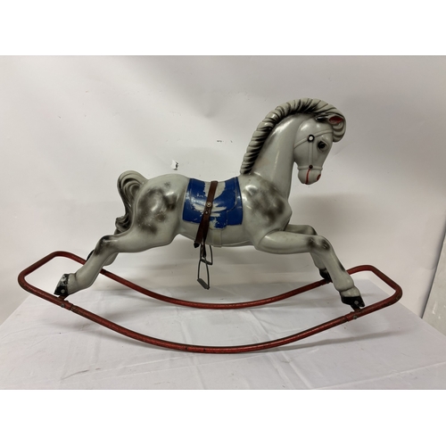 Large plastic rocking horse on metal frame.