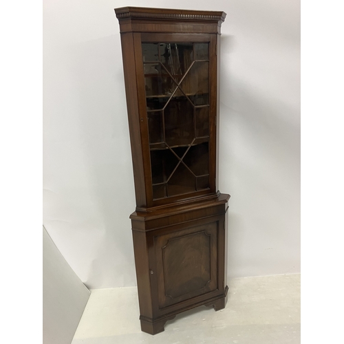 33 - A nicely made mahogany corner cabinet. H. 183cm.