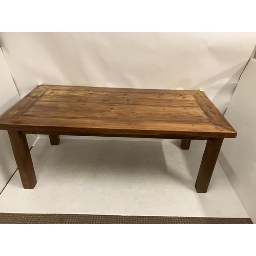 47 - Large pine kitchen table raised on square legs. 200cm x 100cm.