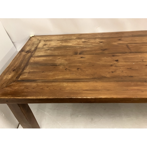 47 - Large pine kitchen table raised on square legs. 200cm x 100cm.