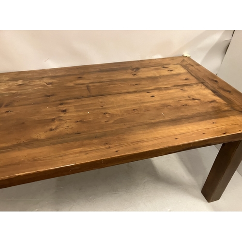 47 - Large pine kitchen table raised on square legs. 200cm x 100cm.