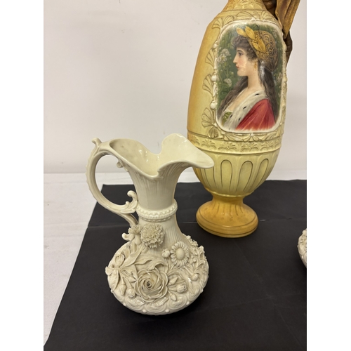 7 - A pair of beleek ewers (black mark, one damaged) together with a tall Austrian china vase. H. 57cm.