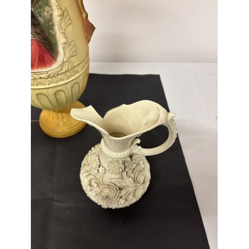 7 - A pair of beleek ewers (black mark, one damaged) together with a tall Austrian china vase. H. 57cm.