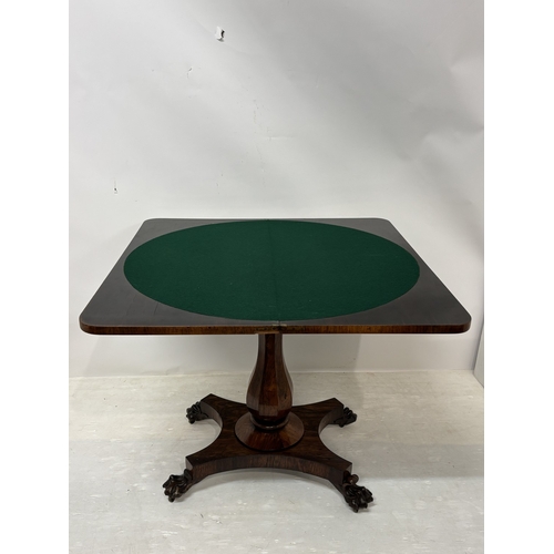 95 - Victorian rosewood fold over card table raised on centre column, platform base and 4 carved feet. W.... 