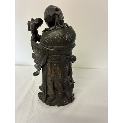 An antique Chinese carved hardwood and silver wire inlaid figure of ...