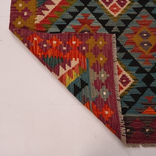 A Kilm rug with geometric design. 148cm x 105cm.