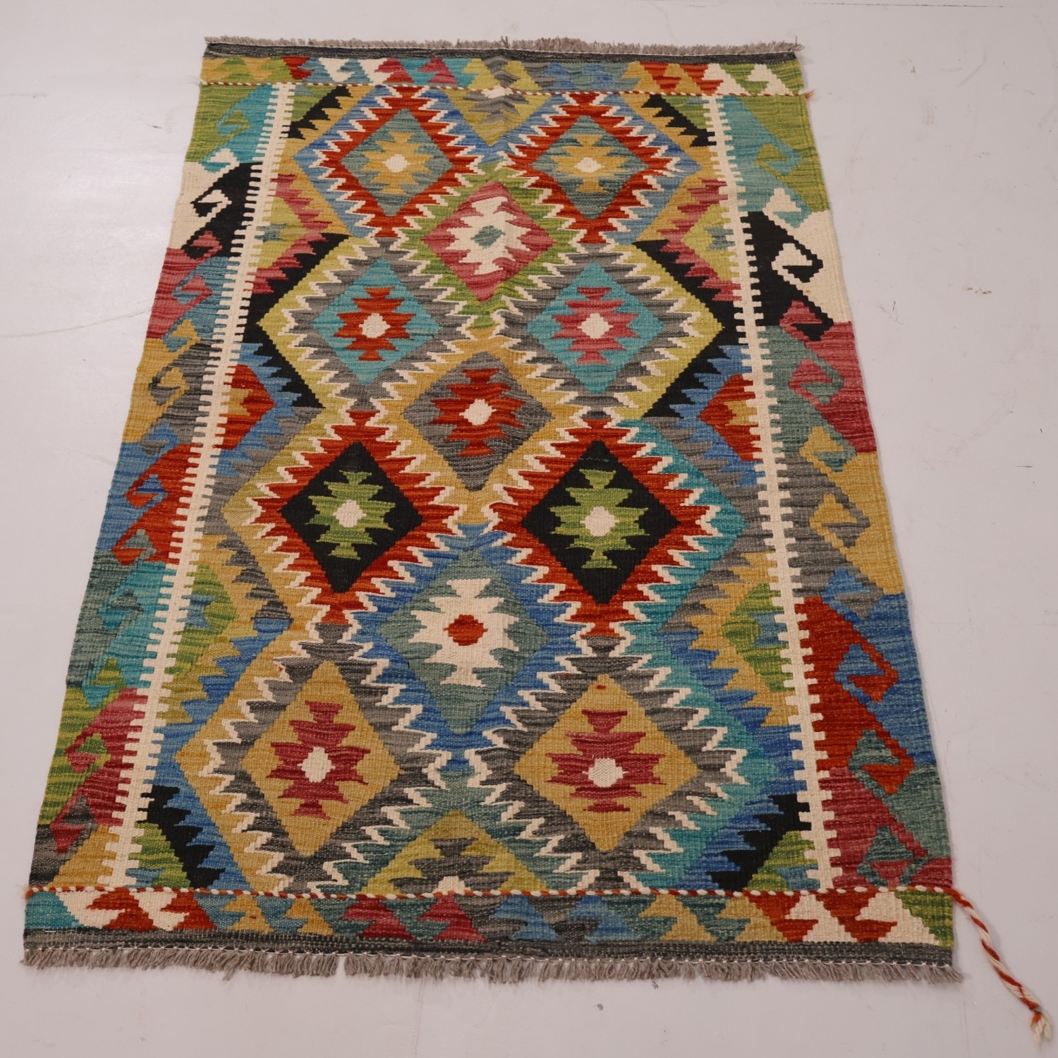 A Kilm rug with geometric design. L 150cm, W. 103cm.