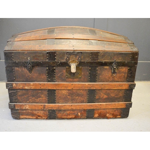 483 - A large 19th century domed chest, with wooden straps.
