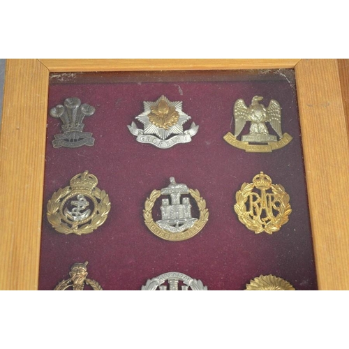 30 - Two framed sets of cap badges.