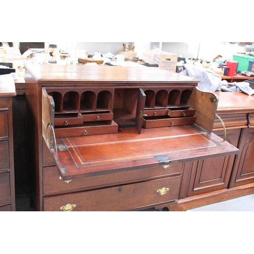 536 - A Georgian oak secretaire chest, the two dummy drawers fold down to reveal a fitted interior of draw... 