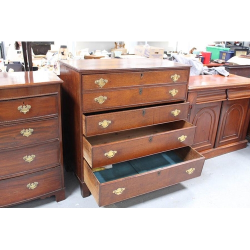 536 - A Georgian oak secretaire chest, the two dummy drawers fold down to reveal a fitted interior of draw... 