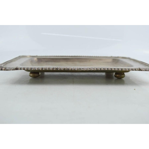 2 - A silver rectangular dish raised on four bun feet, with scallop shells to the corners and decorative... 