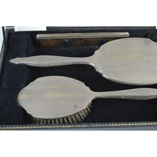 33 - A silver dressing table set, comprising hair brush, hand mirror, clothes brush and comb, in presenta... 