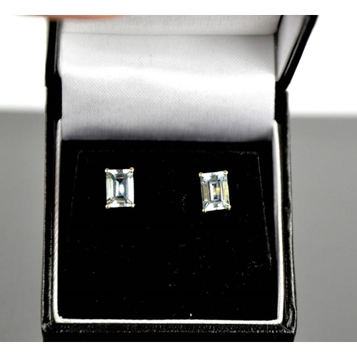101 - A pair of 9ct yellow gold and aquamarine stud earrings, each set with cushion cut 1ct aquamarines.